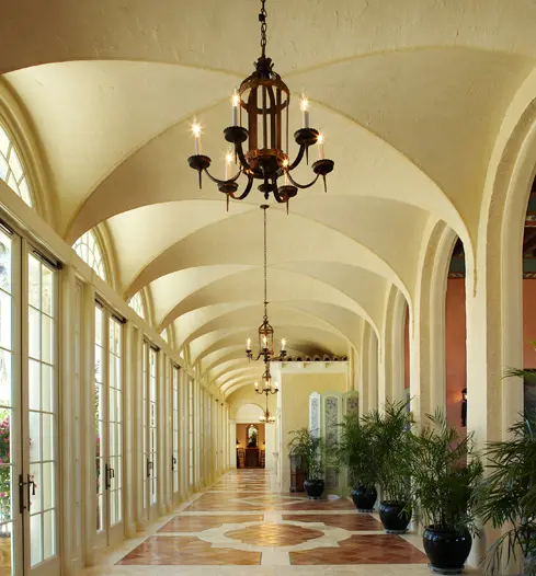 A long hallway with many windows and lights