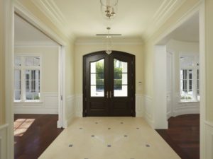 A large entry way with two doors and a tile floor.