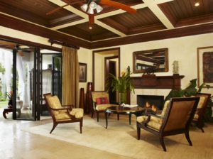 A living room with a fireplace and chairs